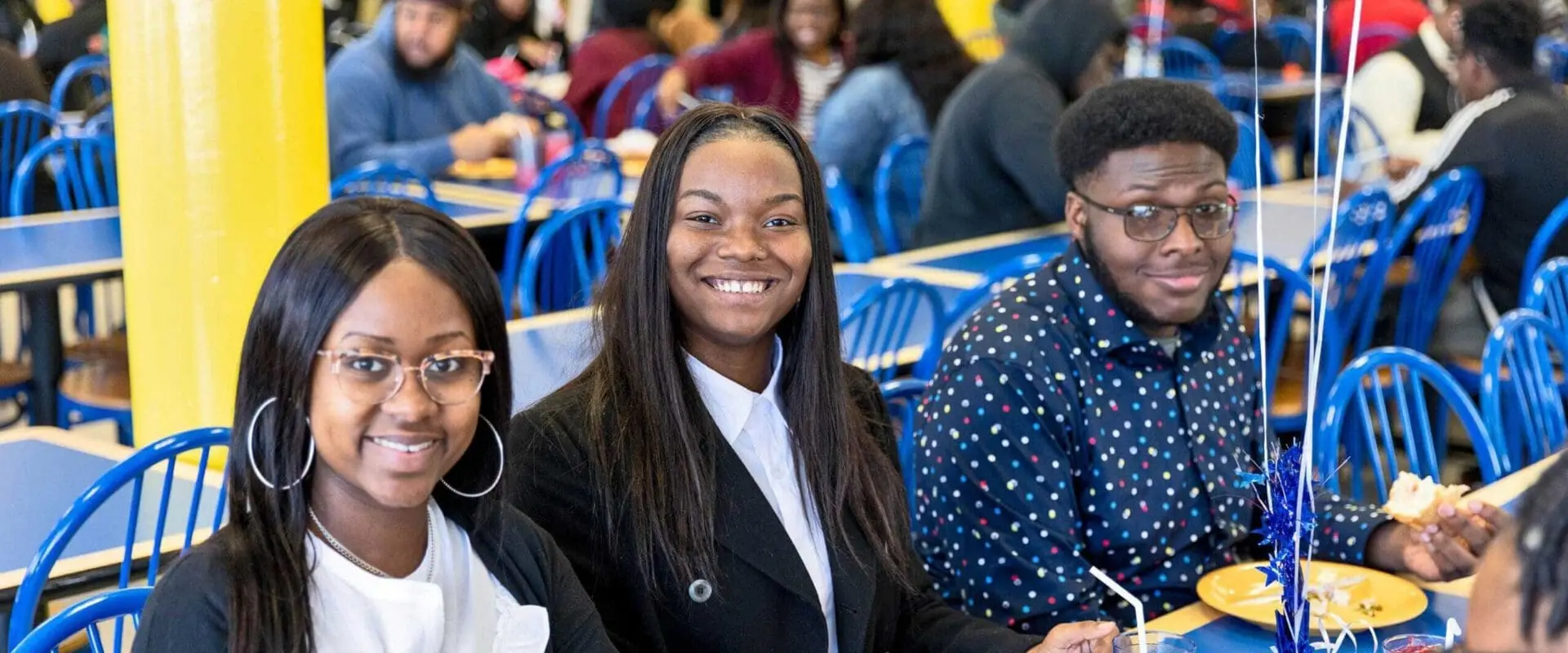 Students sitting at table in cafeteria