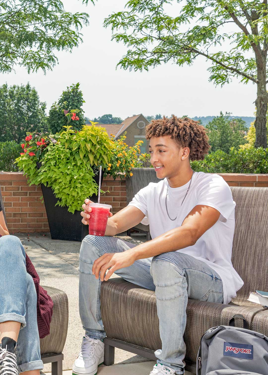 Student enjoying a beverage outside